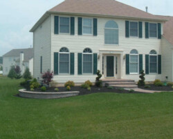 A white house with a green lawn.