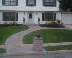 A house with a walkway and a driveway.